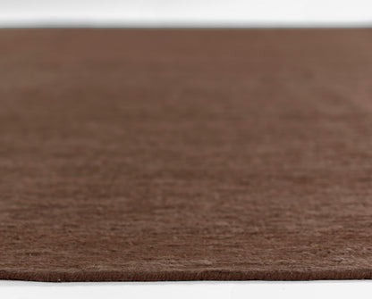 Brown circular shag rug with soft wool-like texture; round floor mat for living areas.