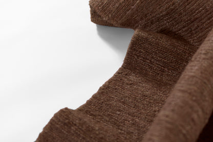 Brown ribbed knit fabric, soft wool texture, draped folds; scarf-like detail.