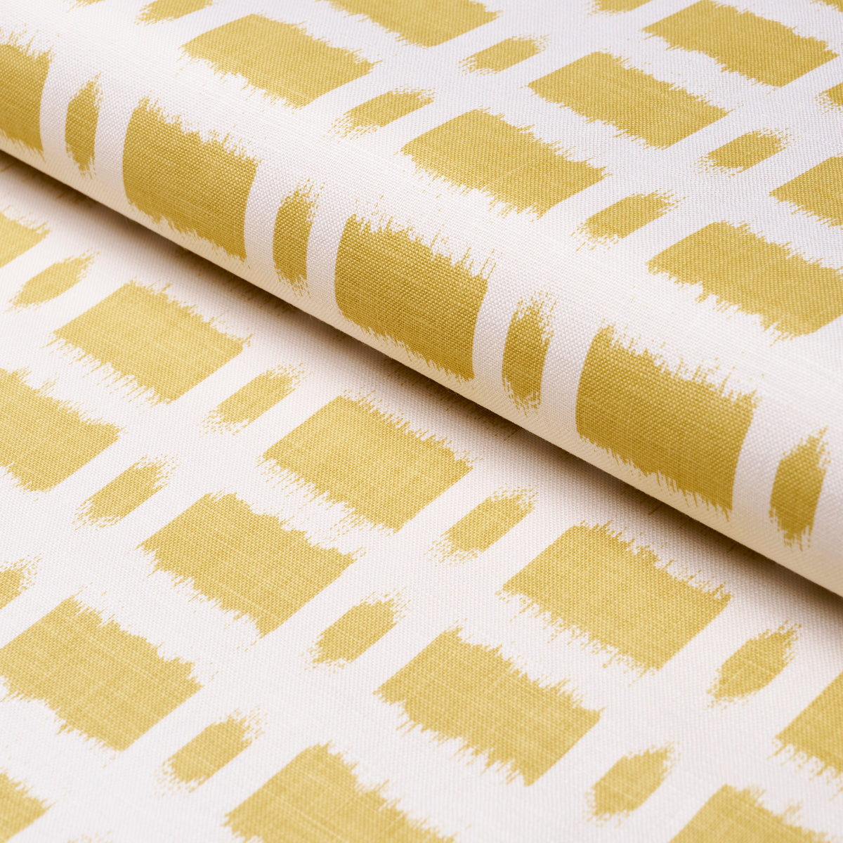White fabric with a gold-yellow brushstroke grid of squares; rolled edge visible.