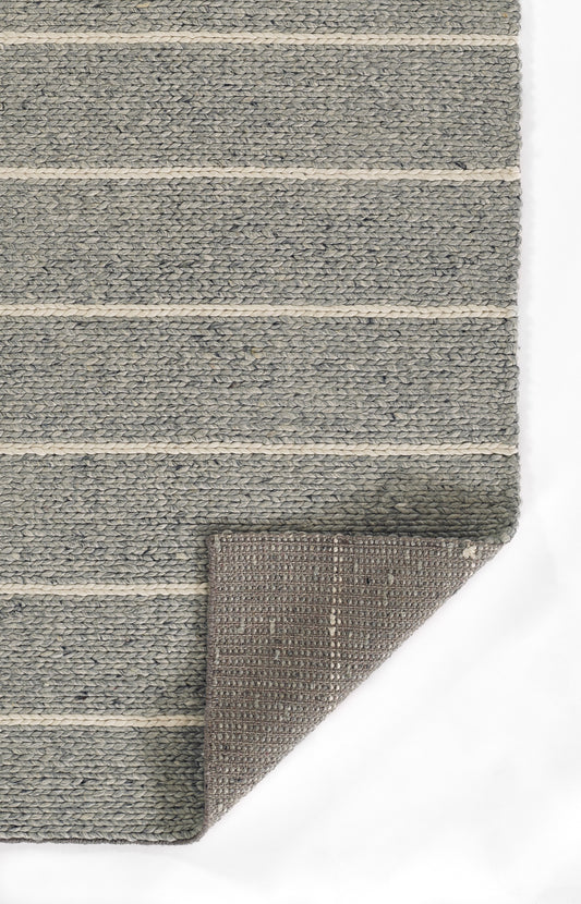 Gray woven rug with cream horizontal stripes; textured surface, rectangular, folded corner reveals brown underside.