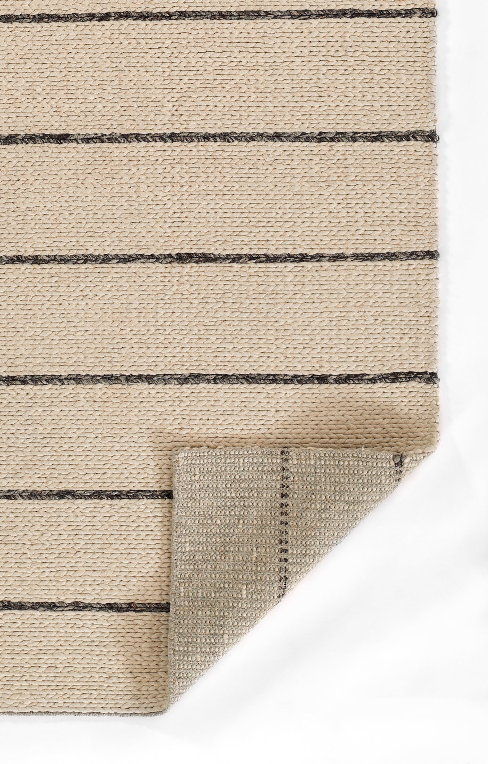 Beige flat-weave rug with dark brown horizontal stripes; woven jute look, folded corner shows underside.