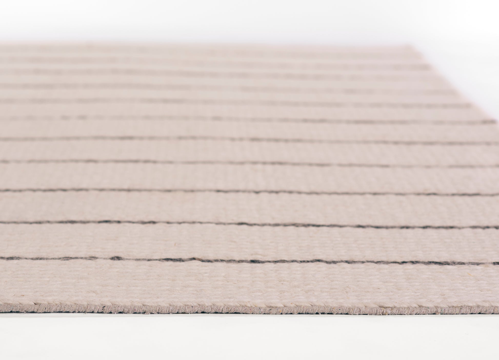 Ivory beige flatweave rug with thin charcoal stripes, rectangular, cozy textured living room accent.