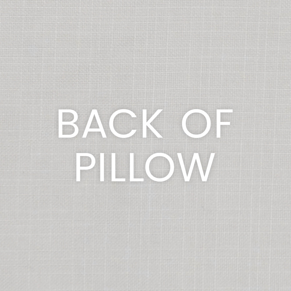 Back of pillow on light grey linen texture with white text.