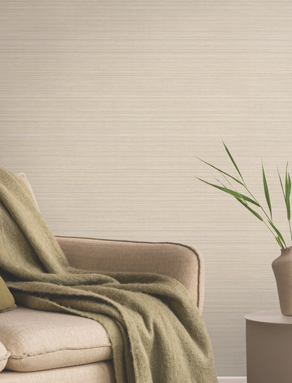 Beige wallpaper on a wall with a subtle pattern in a neutral living room.