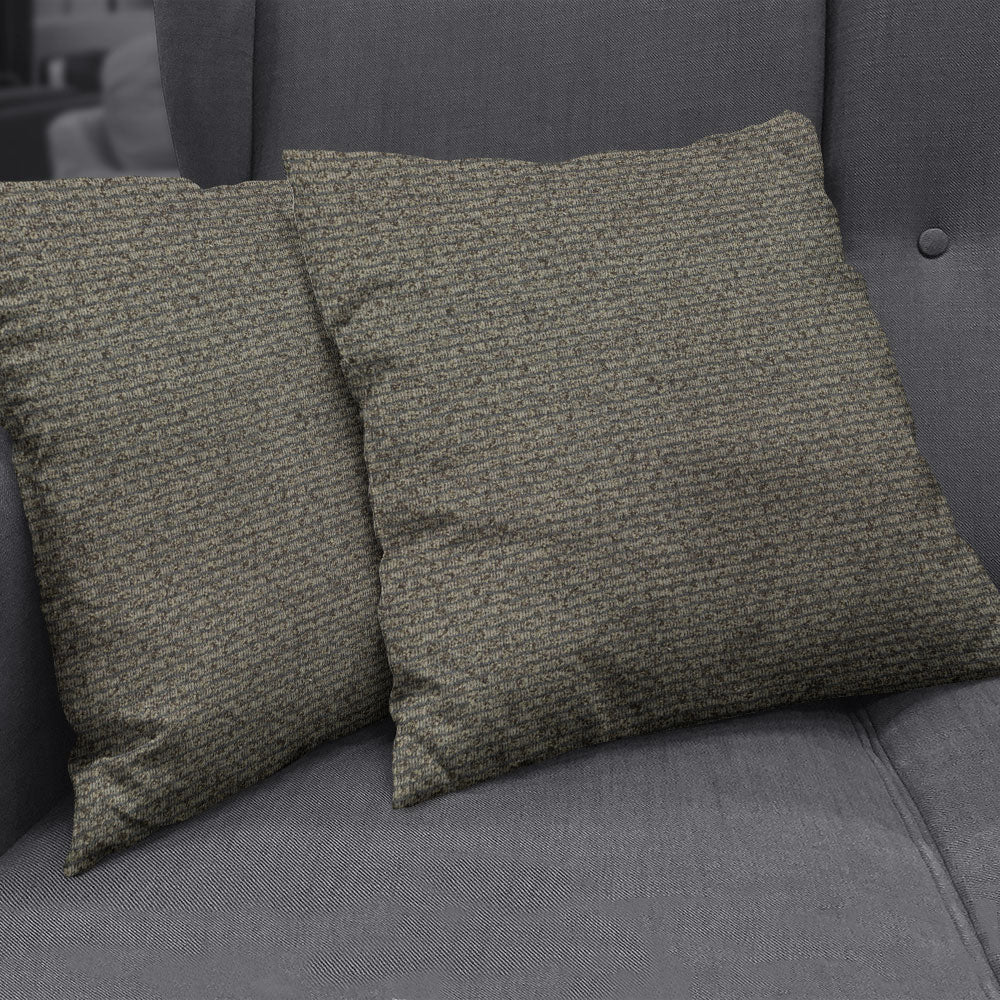 Two square olive-brown textured cushions on a charcoal grey sofa in mocha solid fabric.