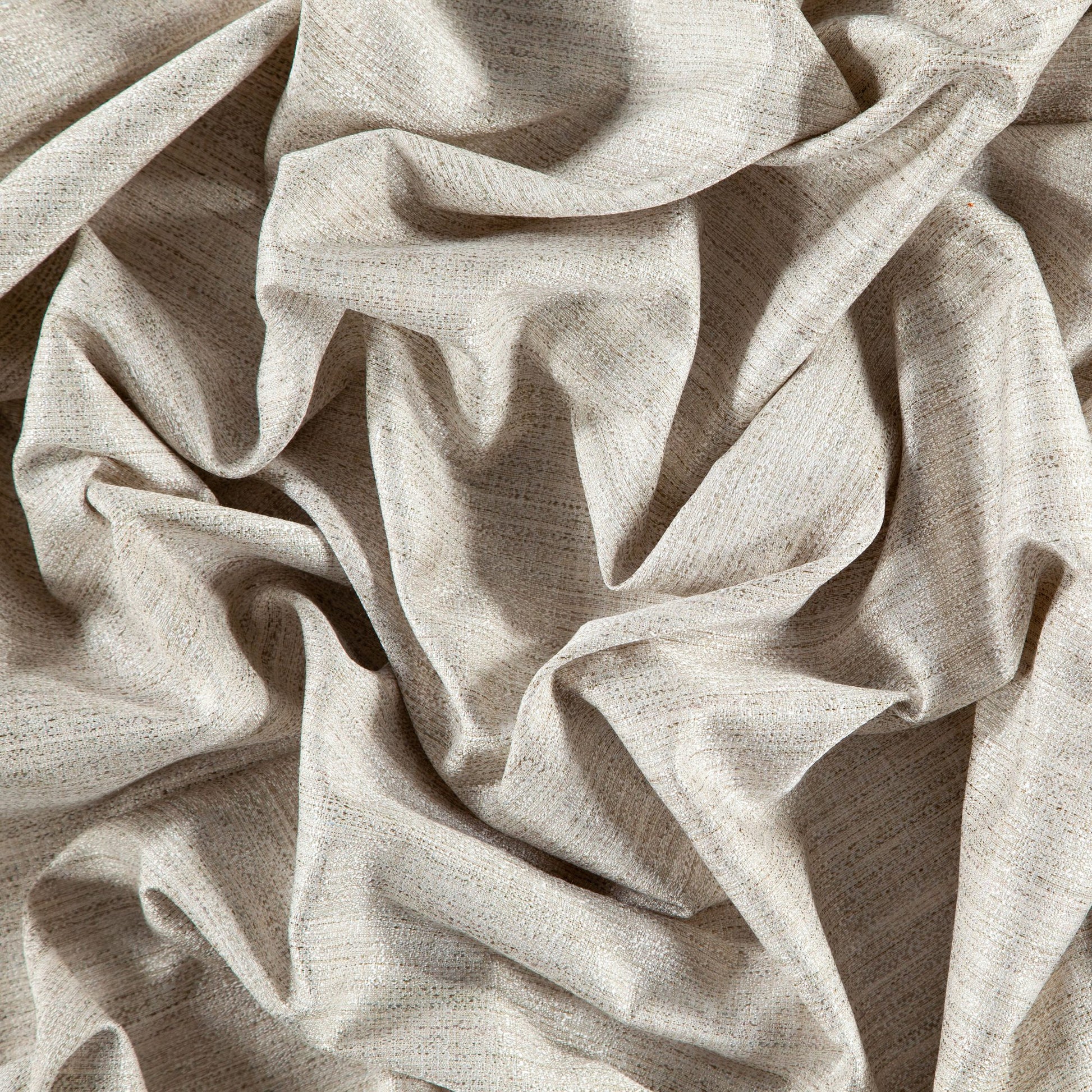 Beige textured linen-look fabric with speckled weave and soft, sculpted folds.