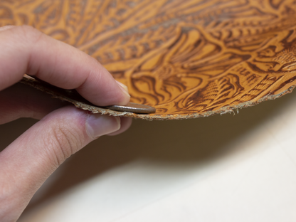 Camel-colored alligator-embossed cowhide leather.