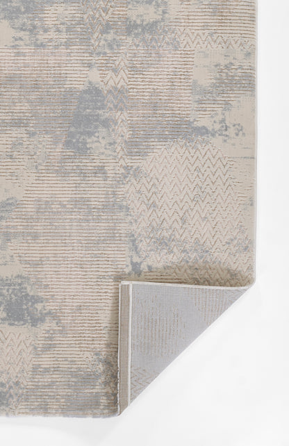 Abstract textured rug in beige, taupe and light gray with chevron and stripe patterns; corner folded to show backing; size 9' x 12'.
