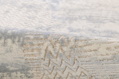 Beige, gray and pale blue tufted area rug with an abstract zigzag pattern; soft textured geometric living-room rug.