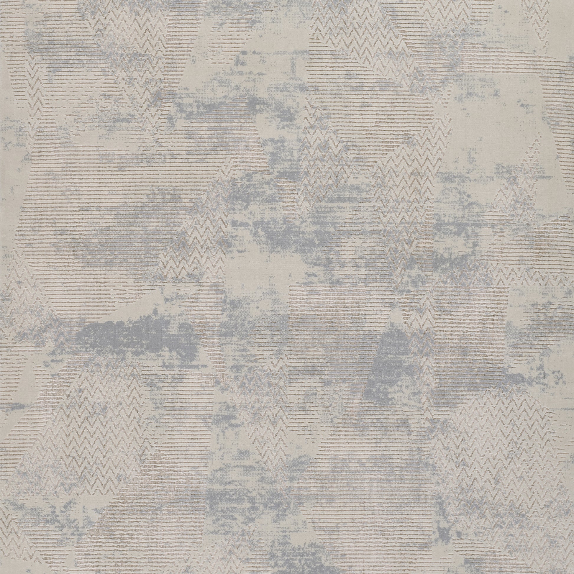Abstract geometric area rug in beige and blue-gray tones with chevron and triangle patterns.
