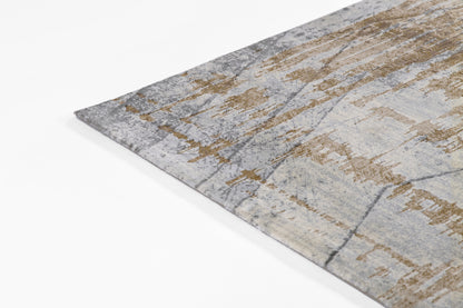 Abstract gray and beige area rug with gold-taupe accents and distressed pattern, soft pile.