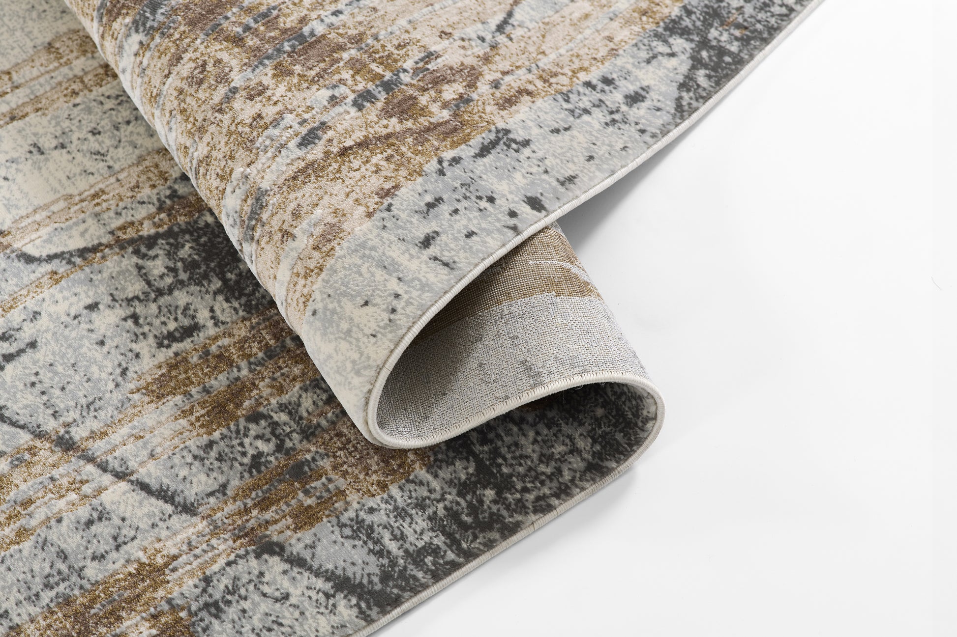 Abstract distressed area rug in gray, beige & bronze tones, plush pile, rolled edge with light backing; modern decor.