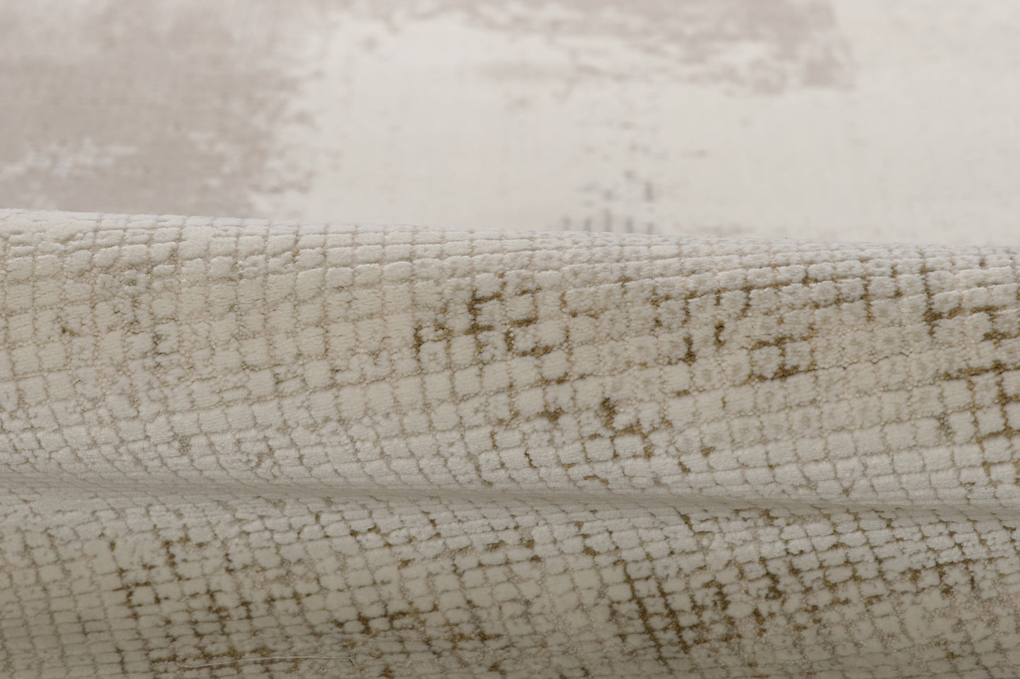 Cream ivory rug with taupe crackle grid pattern; soft woven, low-pile, rolled-edge rug.