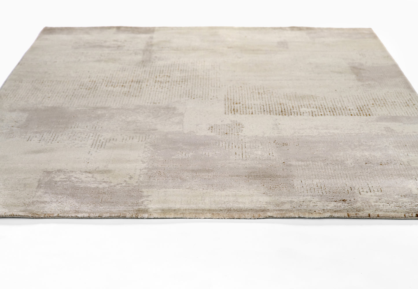 Neutral beige-gray patchwork area rug with subtle textured blocks and light pile for living room decor.