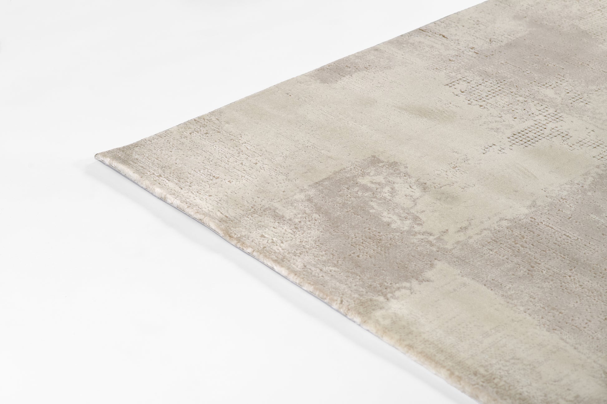 Beige & ivory distressed runner rug with patchwork textures in soft, muted tones.