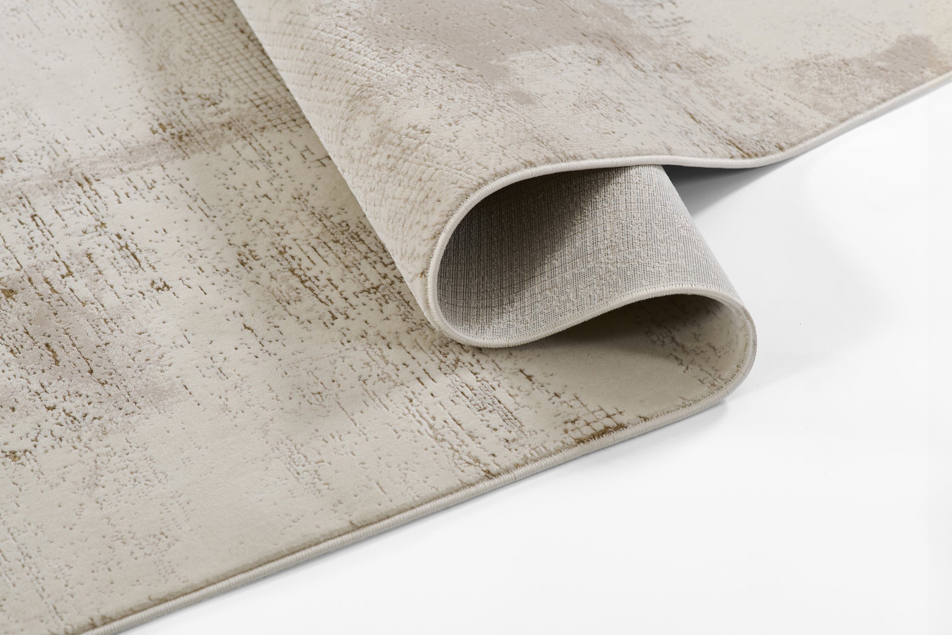 Beige distressed-pattern rug with ivory tones; soft woven surface, rolled corner reveals light grey backing.