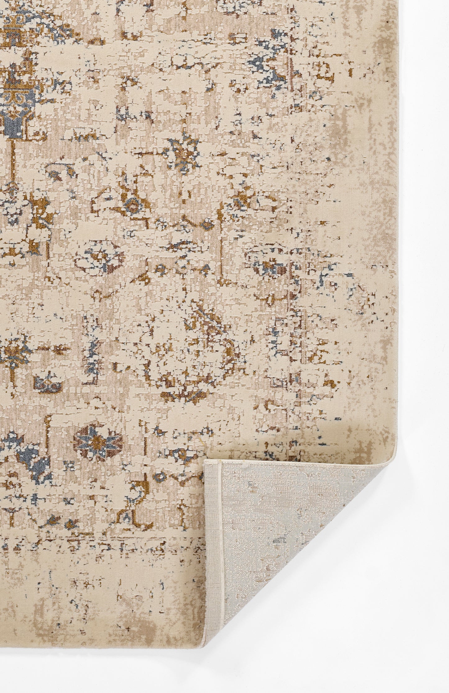 Beige distressed oriental rug with blue & brown floral motifs; folded corner shows light backing.