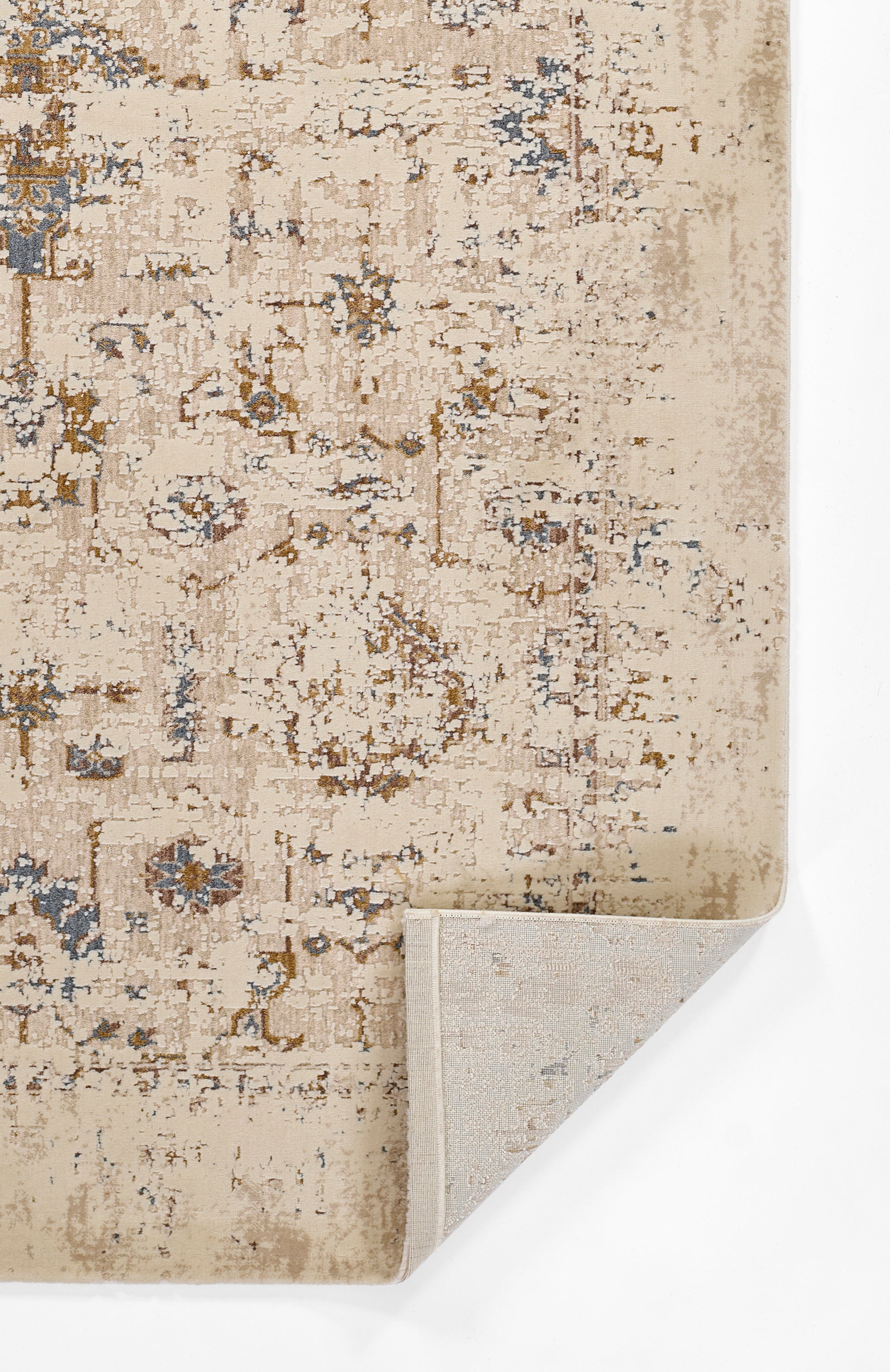 Beige distressed oriental rug with blue & brown floral motifs; folded corner shows light backing.