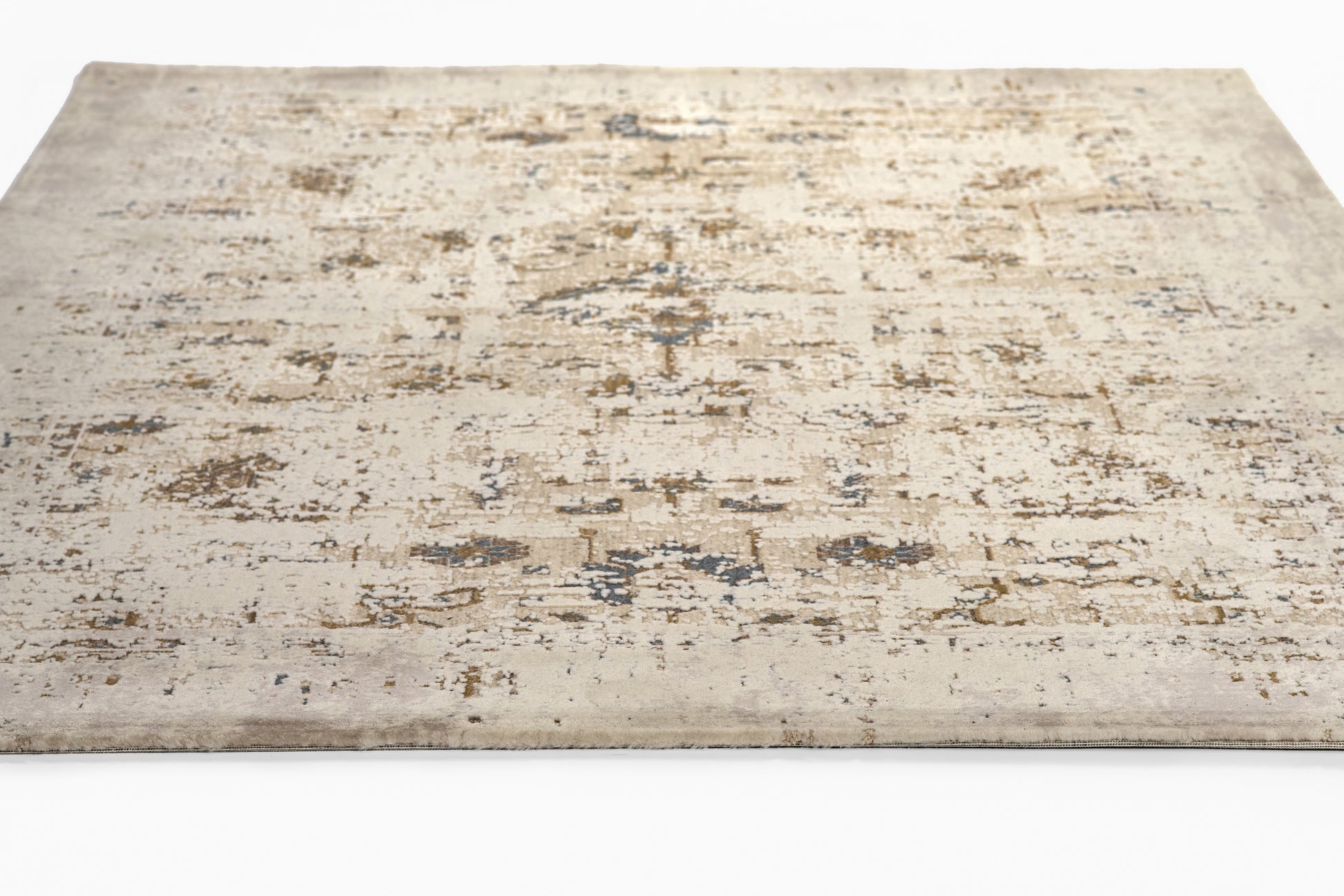 Beige distressed flat-weave rug with muted blue and brown patches; rectangular, vintage-inspired for living spaces.