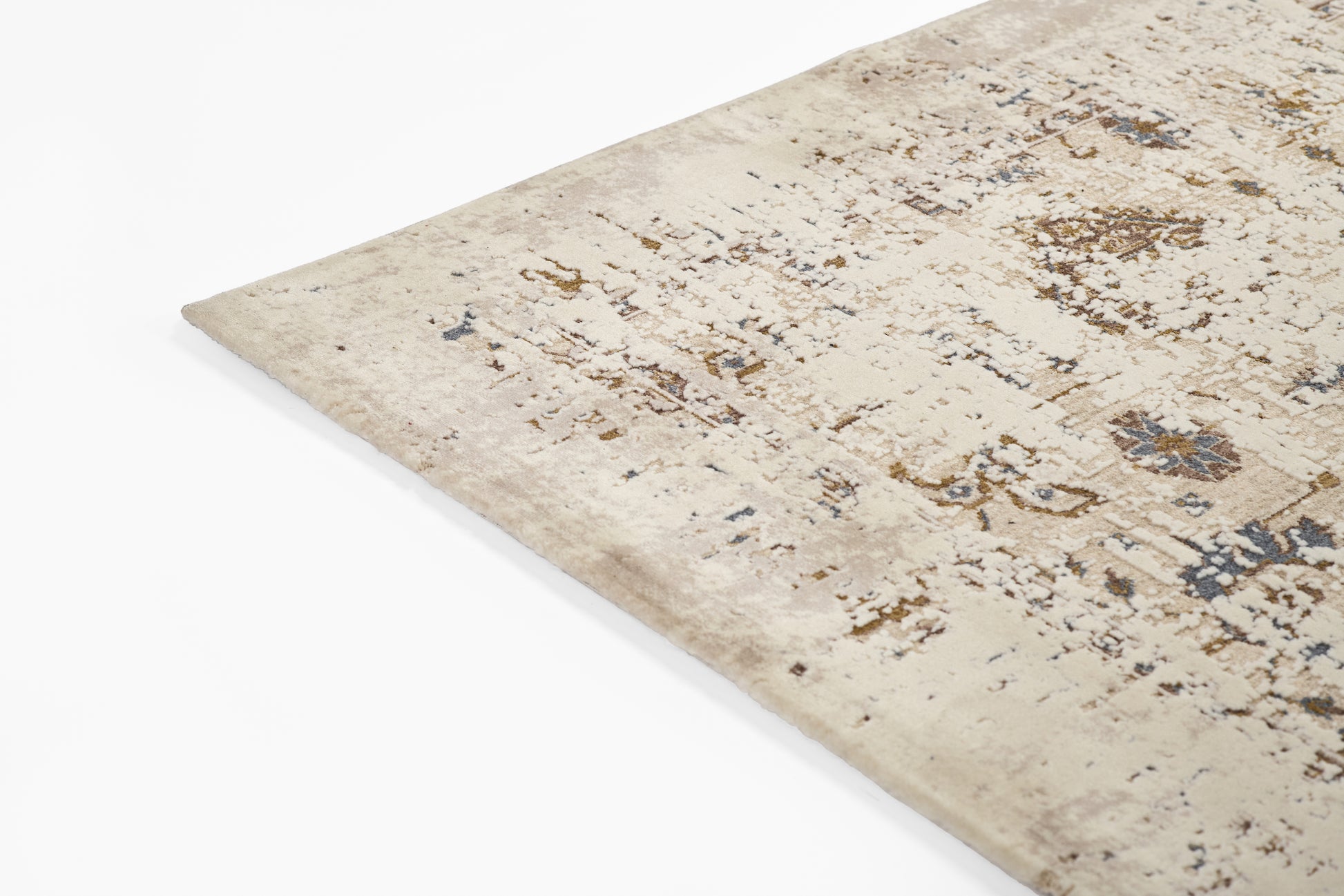 Beige distressed oriental rug with blue and brown accents; rectangular corner visible and plush texture.