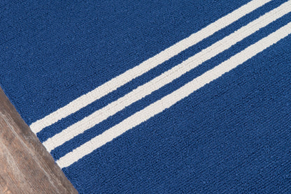Blue textured area rug with two cream stripes running diagonally; plush pile on wood floor.