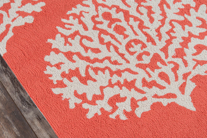 Red 9' round rug with a white coral-pattern motif on a wooden floor