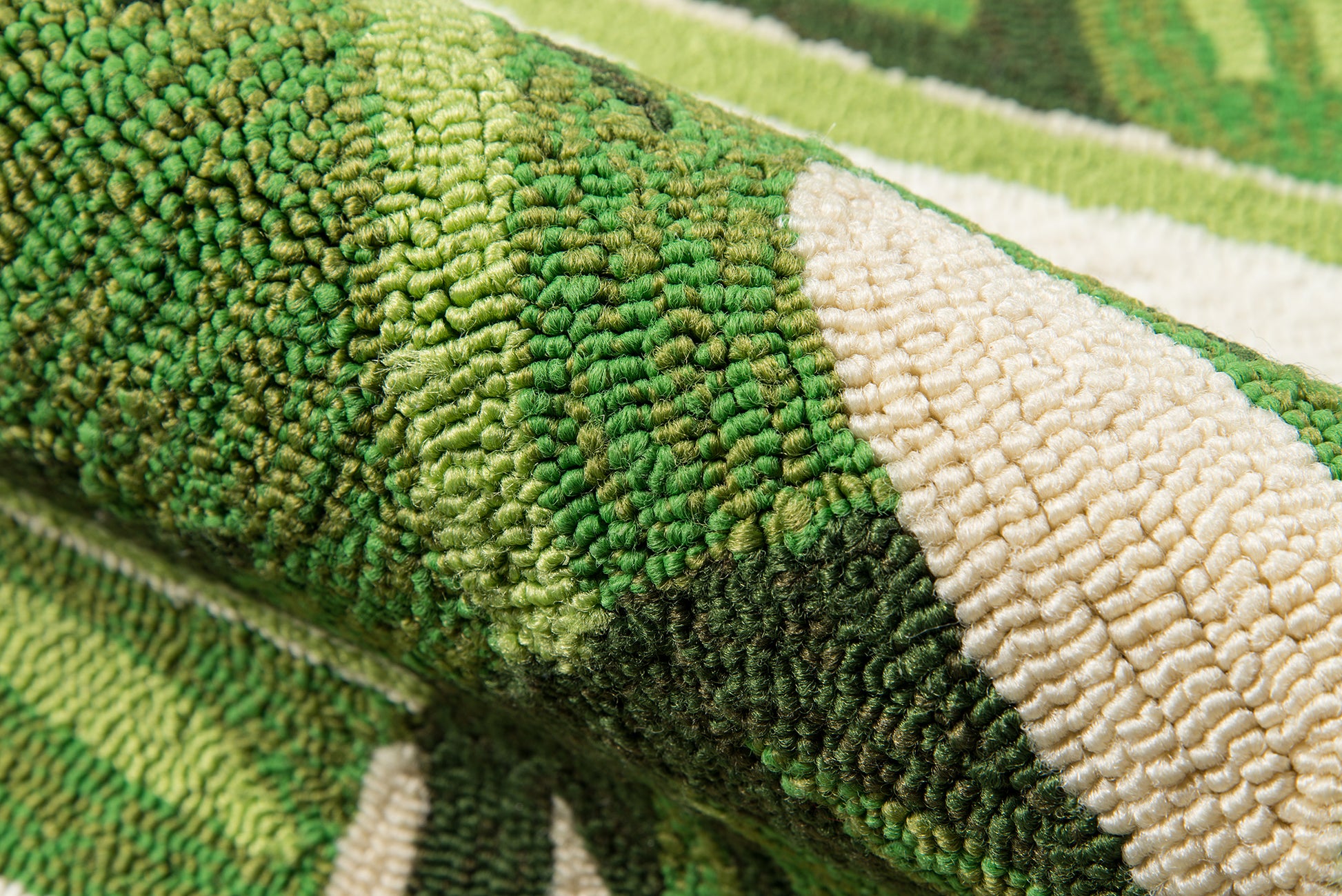 Close-up of a green-toned woven rug with dense loop pile in olive, lime, and cream stripes.