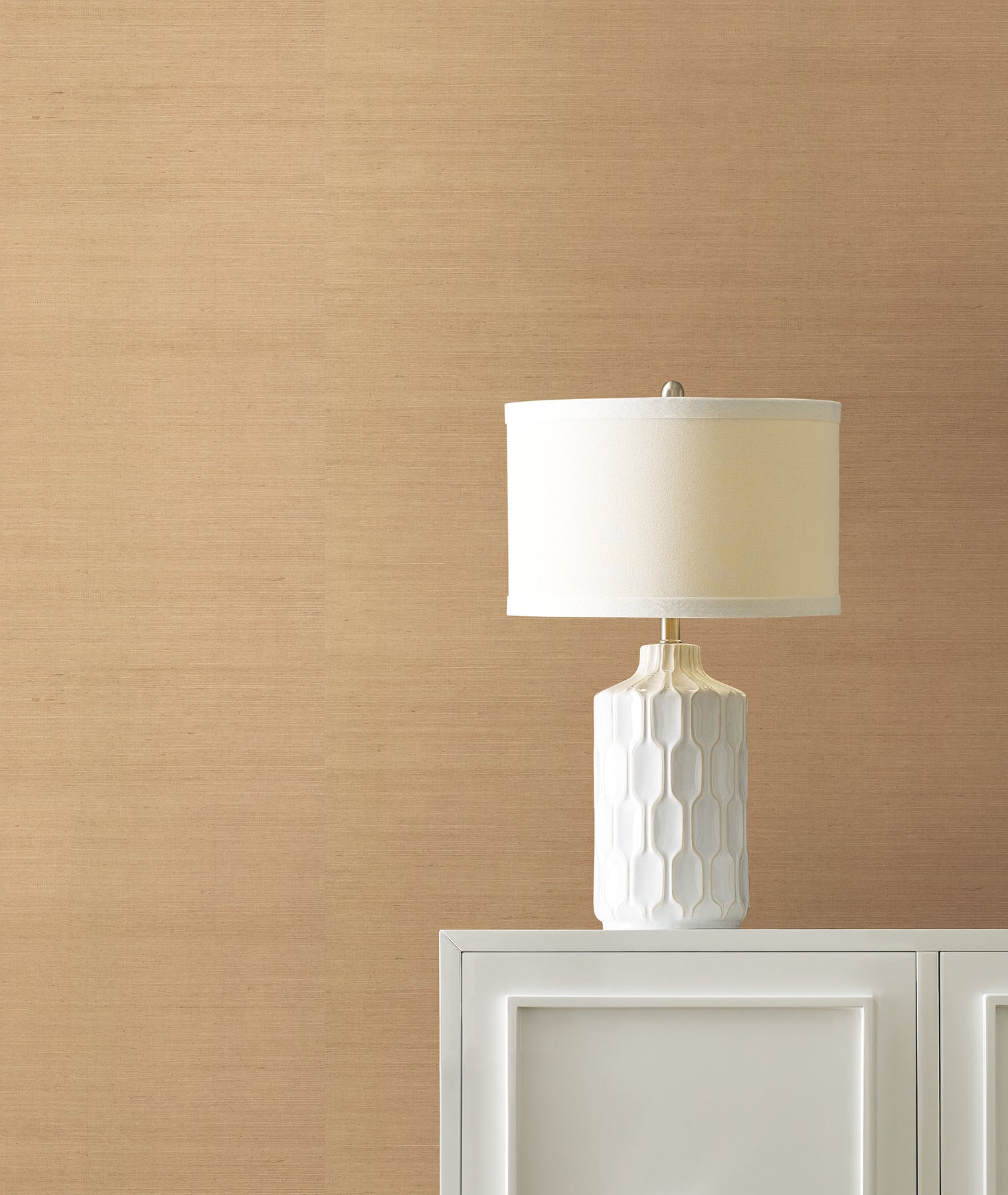 Light grey grasscloth wallpaper with a subtle textured finish on a wall in a room.