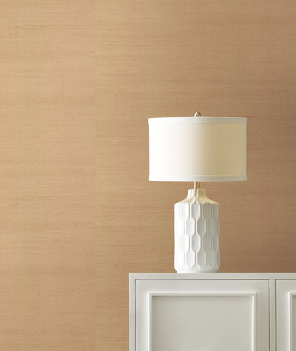 Light grey grasscloth wallpaper with a subtle textured finish on a wall in a room.