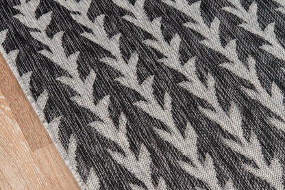 Charcoal and light gray chevron woven rug, rectangular, modern style for living room or entryway.