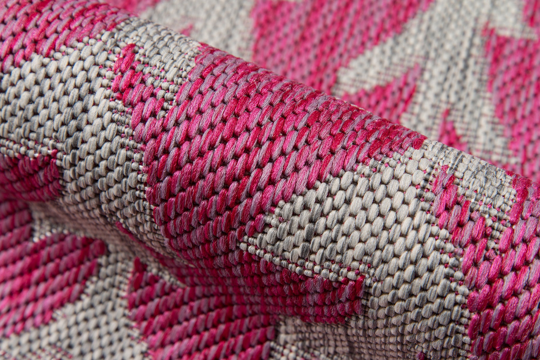 Close-up of pink & beige woven rug runner (2' x 6') with a jacquard pattern.