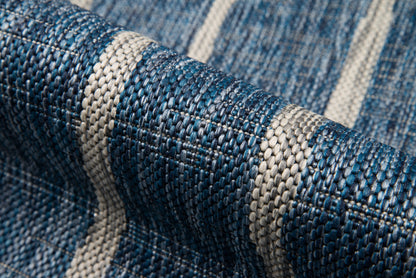 Close-up of blue and cream striped woven fabric with a tight, denim-like weave.