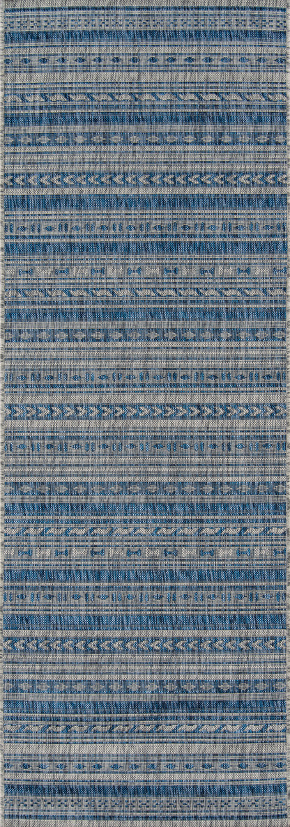 Blue and white striped woven runner rug with geometric texture and repeating band patterns.