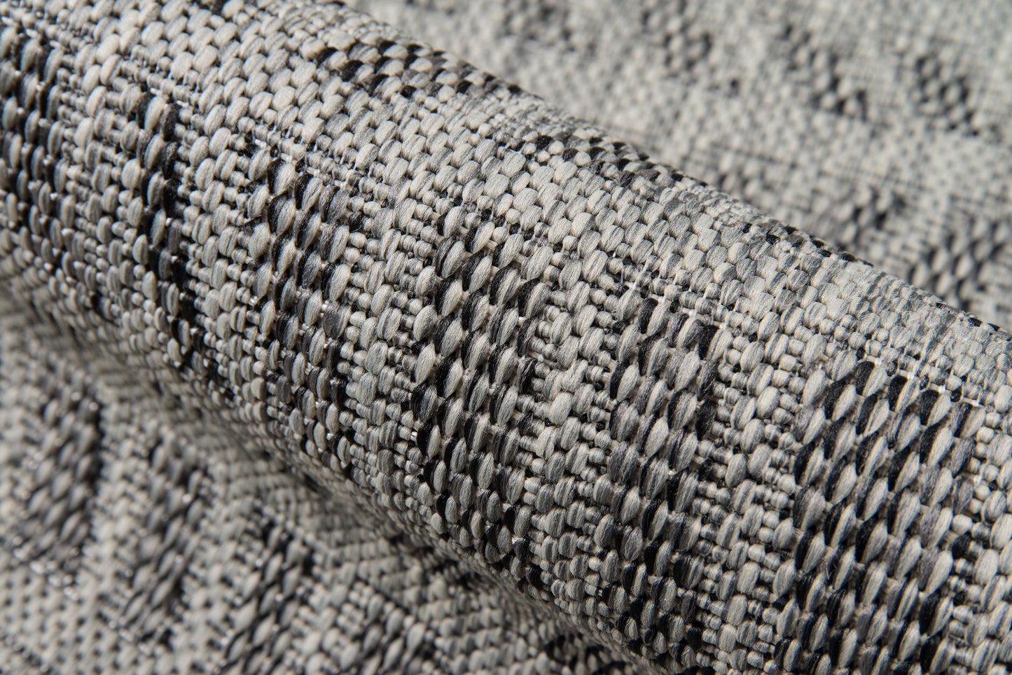 Gray textured woven rug runner with a looped, speckled pattern.