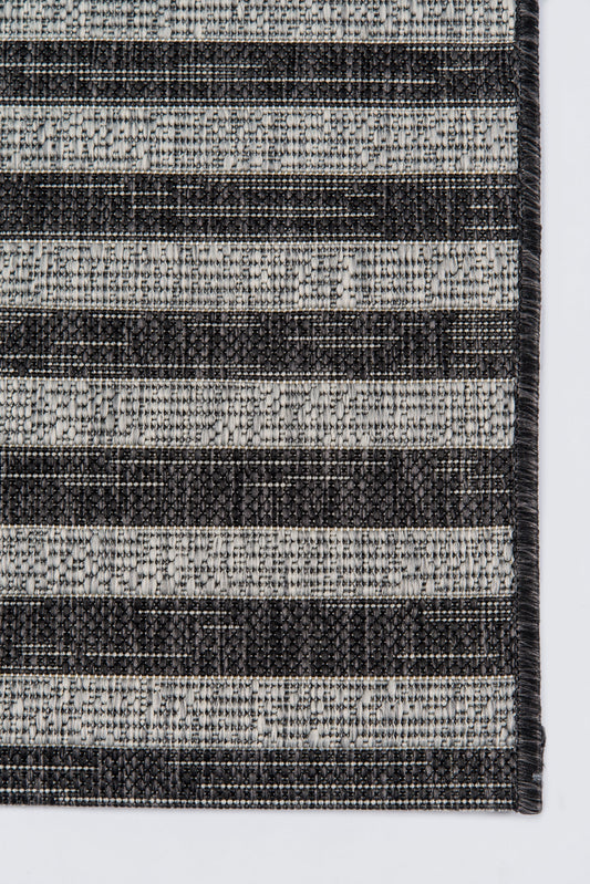 Charcoal and light gray striped woven rug with a textured flat-weave finish.