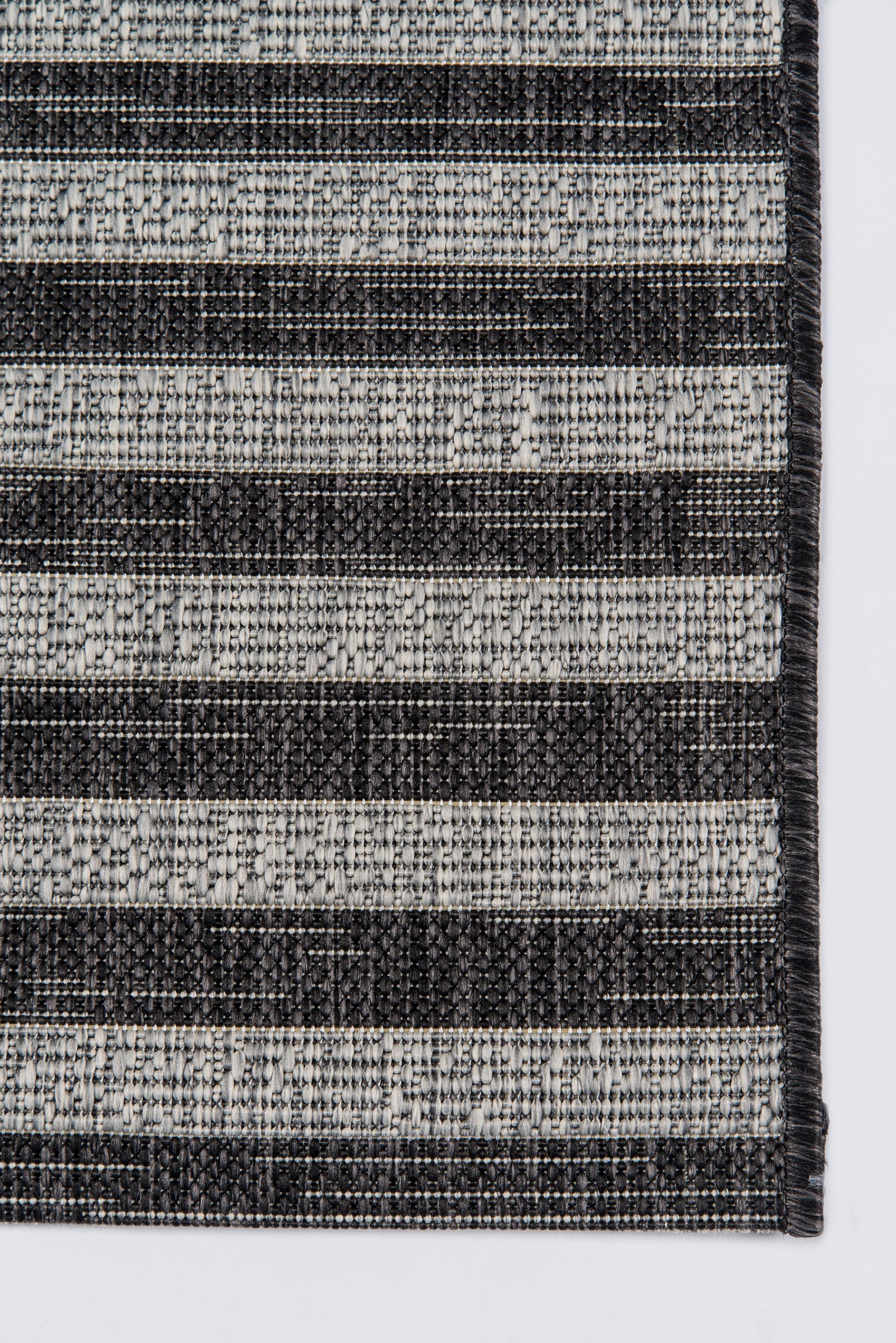 Woven striped rug with alternating charcoal & light gray stripes; textured boucle weave.