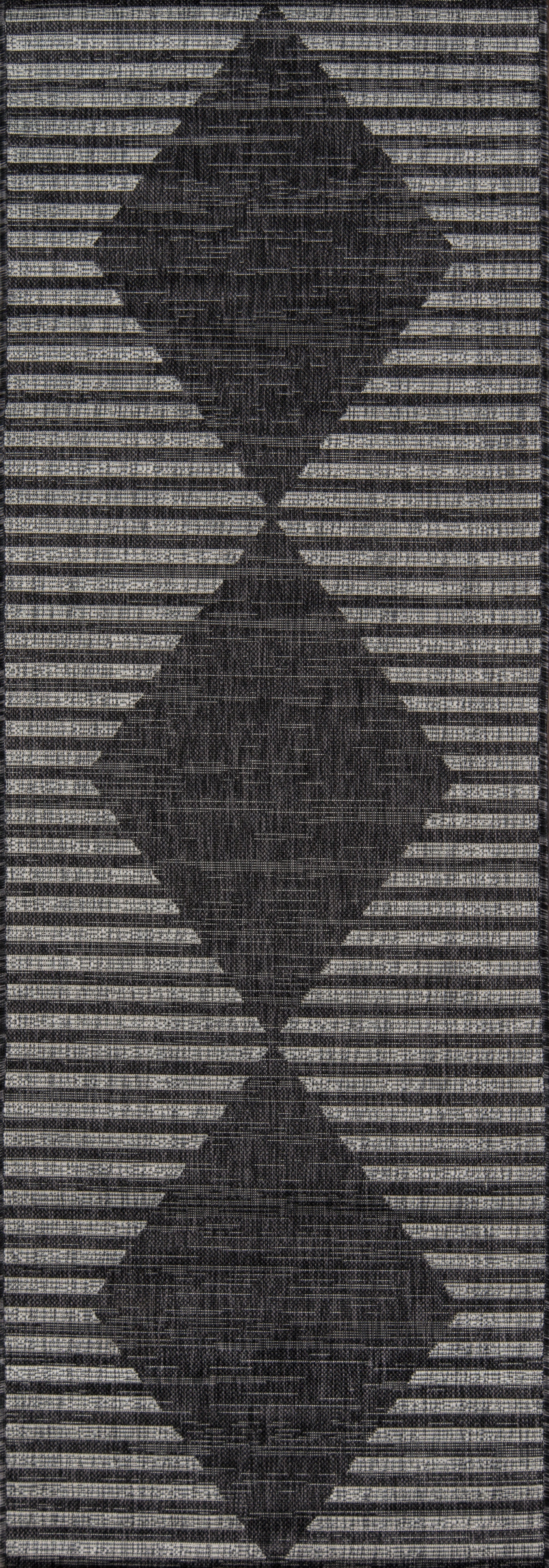 Charcoal 9' x 13' rug with three stacked diamond motifs on a striped gray background; woven geometric texture.