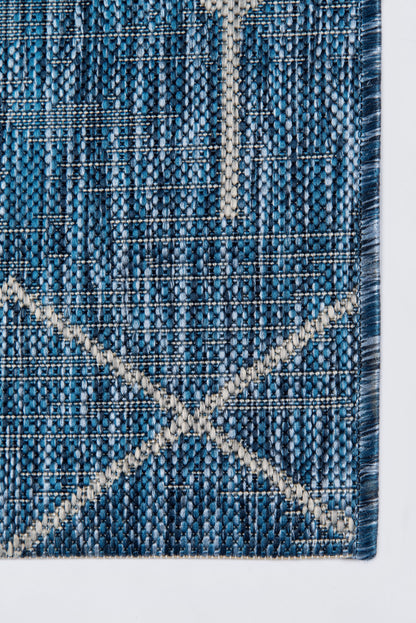 Blue woven rug with cream geometric X motif and denim-textured weave.