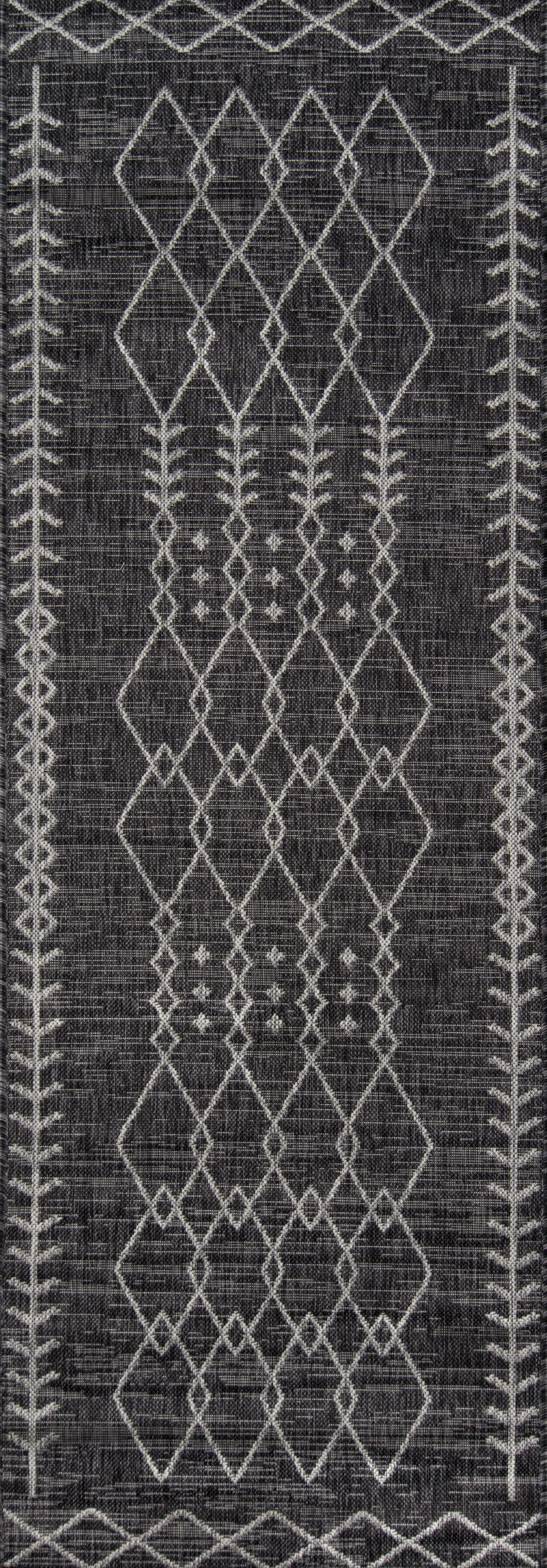 Charcoal woven rug featuring white geometric diamond lattice and leafy bordered edges.