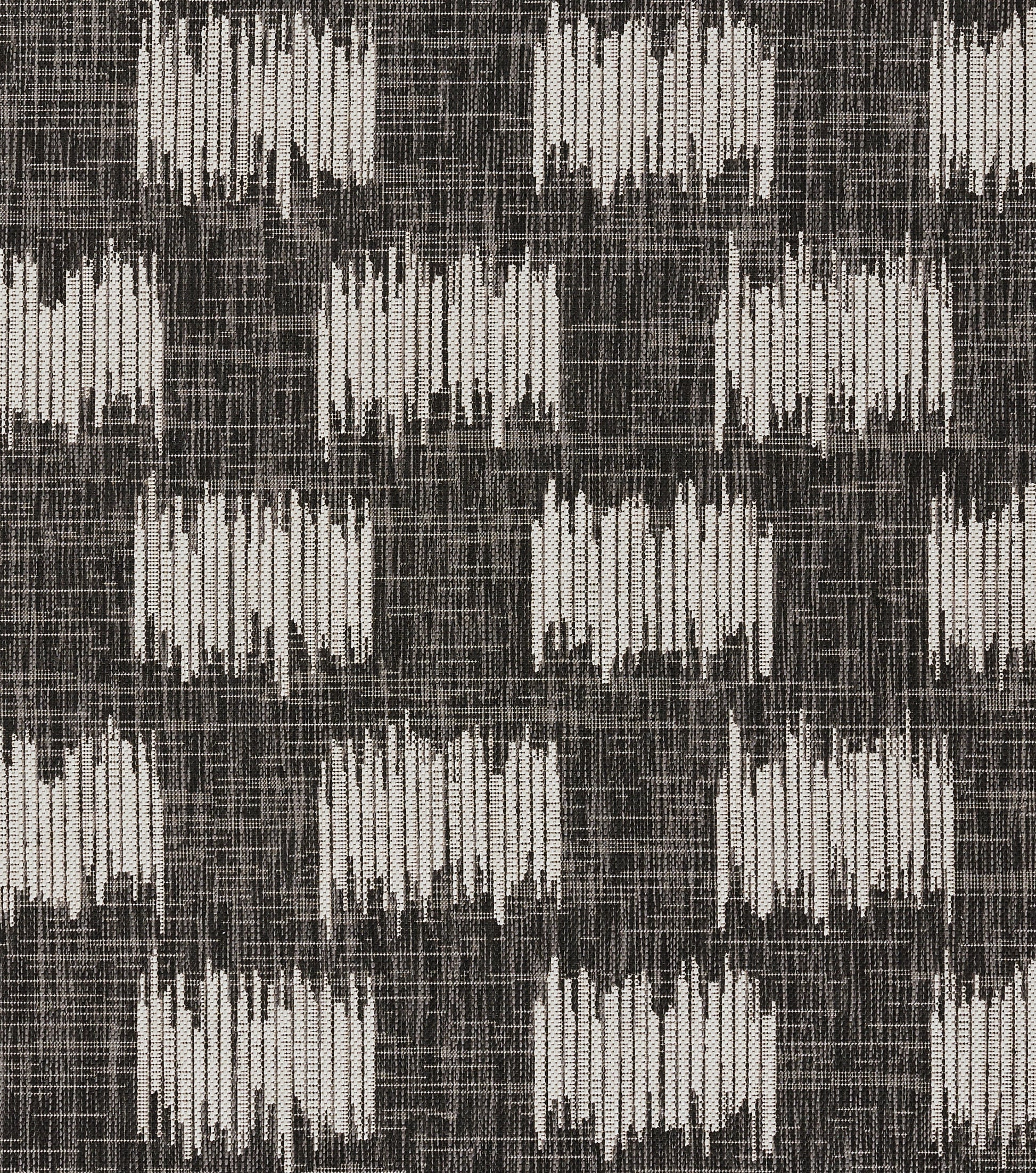 Geometric woven rug with light beige rectangular blocks on a dark charcoal background.