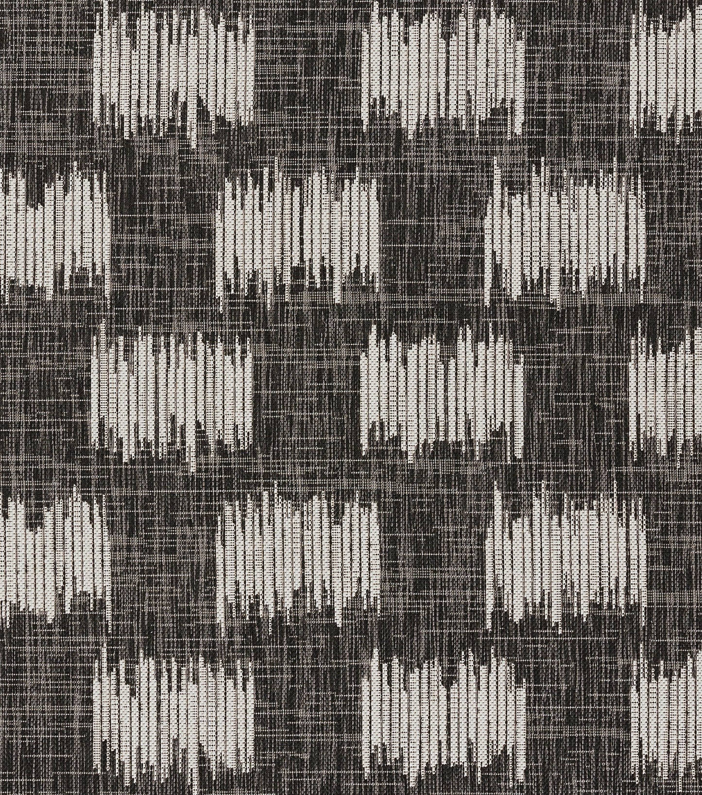 Dark charcoal rug with off-white vertical brush-like bars in a repeating checkerboard grid.