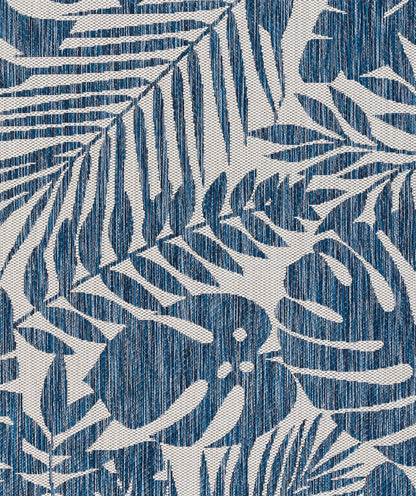 Blue and white palm leaf print fabric; woven textile with tropical leaf motif, ideal for curtains or cushions.