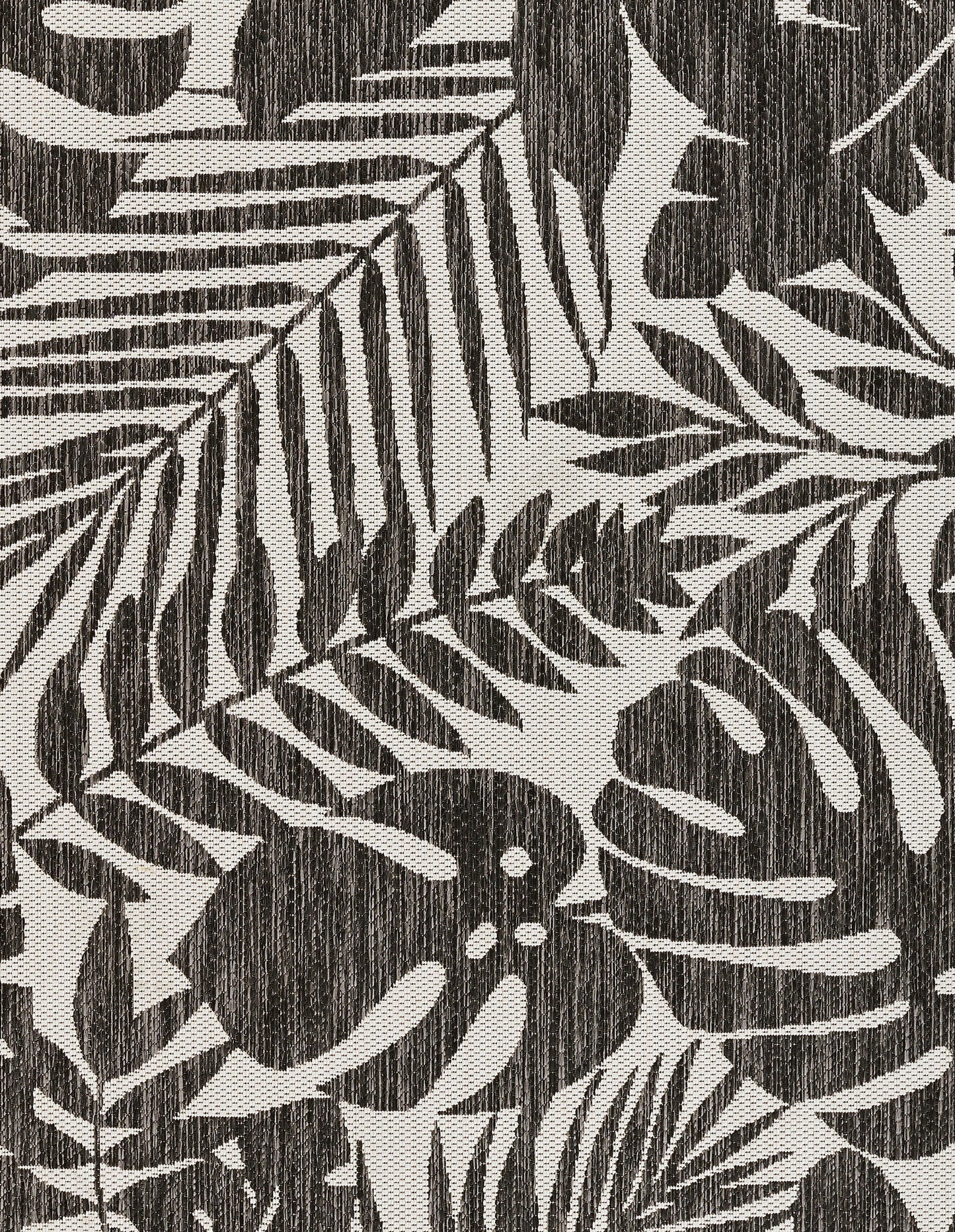 Charcoal fabric with cream botanical print featuring palm fronds and monstera-like leaves, woven texture.