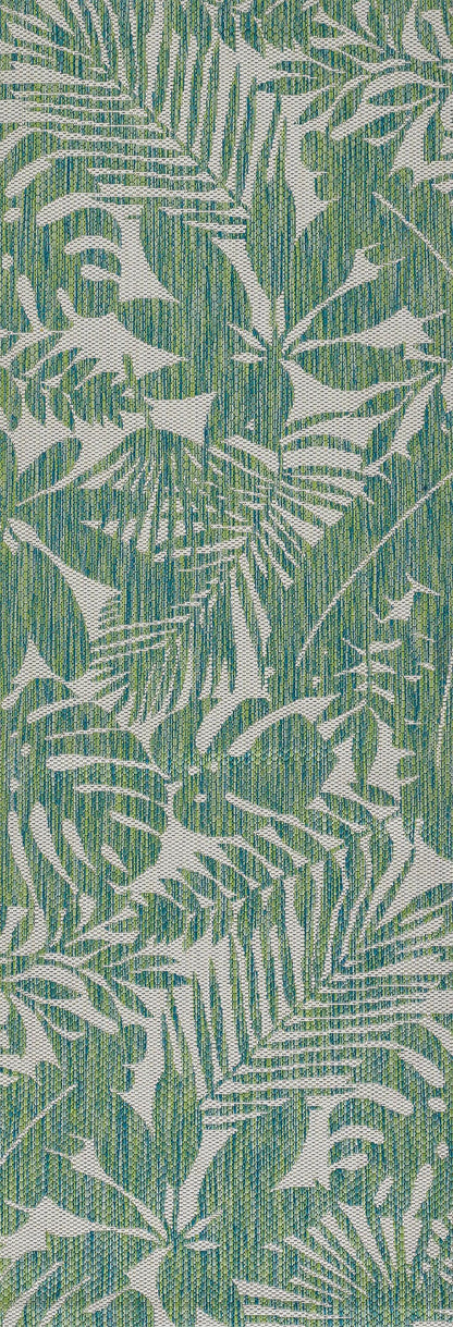 Green background fabric with white tropical palm leaf print, botanical pattern, textile material.