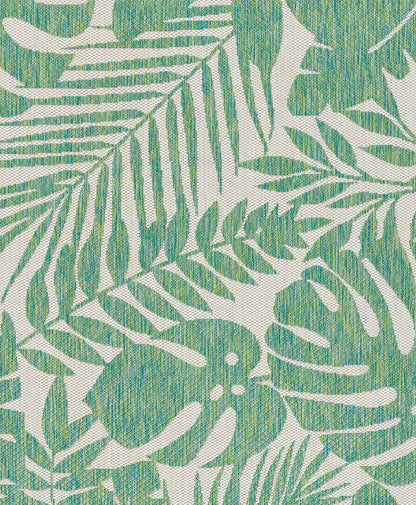 Green tropical palm leaf print on cream woven rug; 7' x 10'.