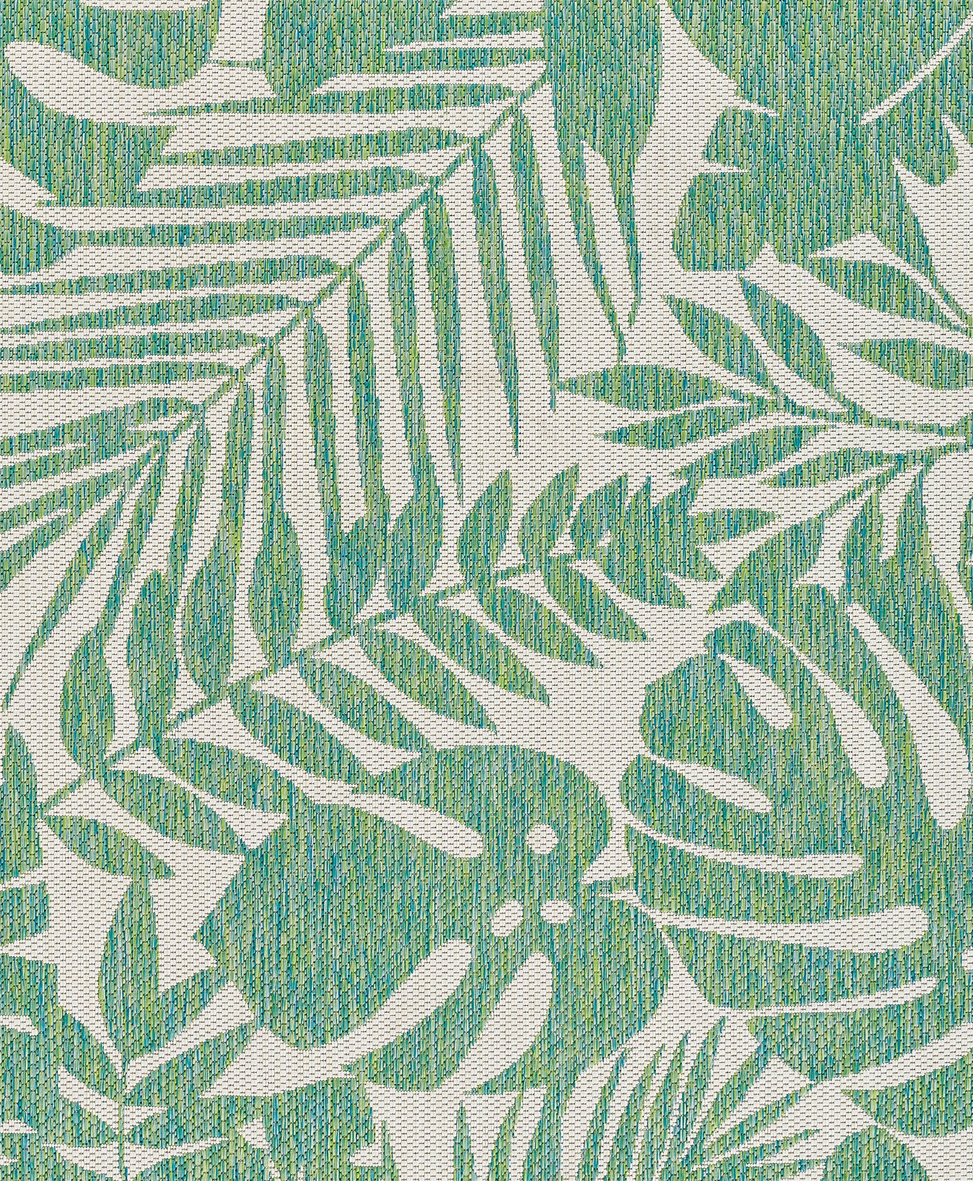 Green tropical leaf print rug featuring palm and monstera fronds on beige background.