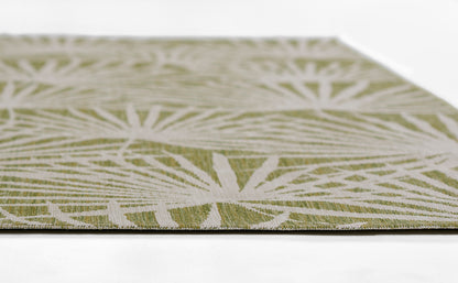 Close-up of olive-green flat-weave rug with white geometric starburst pattern and woven texture.