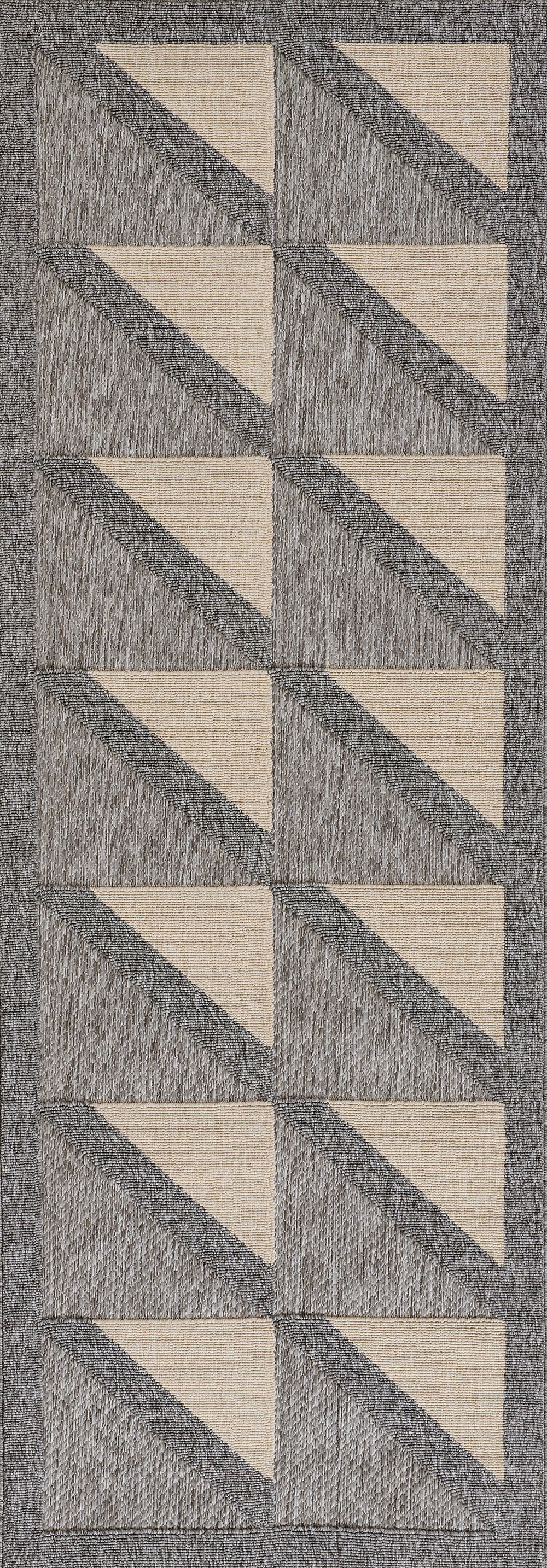 Grey woven runner rug with repeating beige diagonal triangles forming vertical zigzag chevrons.