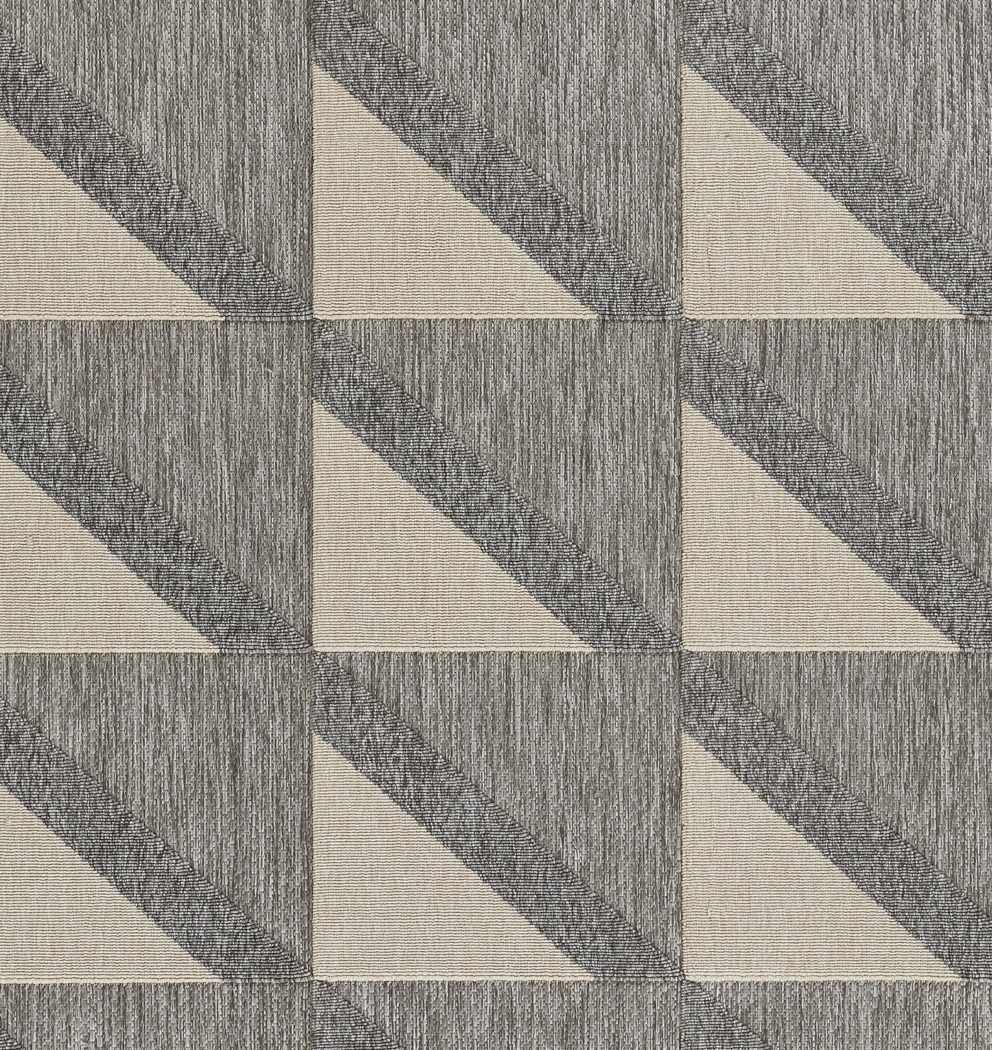 Gray and beige geometric square tile pattern with diagonal beige triangles and textured charcoal halves.