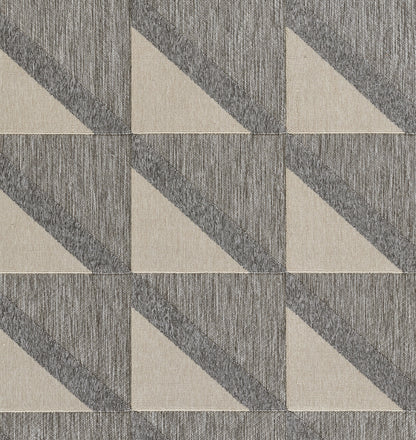 Grey and beige woven rug with a geometric pattern of diagonal triangular tiles, 5' x 8'.